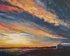 Vibrant sunset with dramatic clouds over a serene landscape.