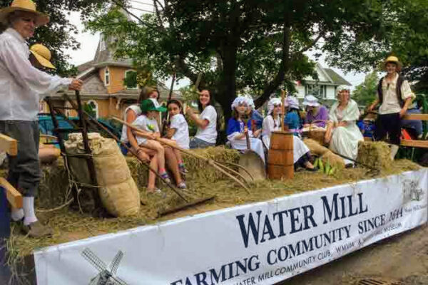 Parade float with people in historical costumes.
