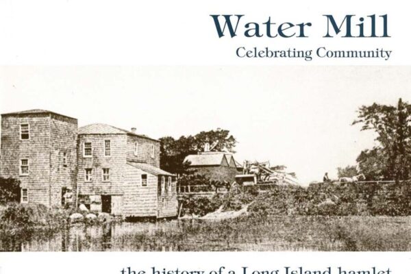 Historic water mill with surrounding landscape.