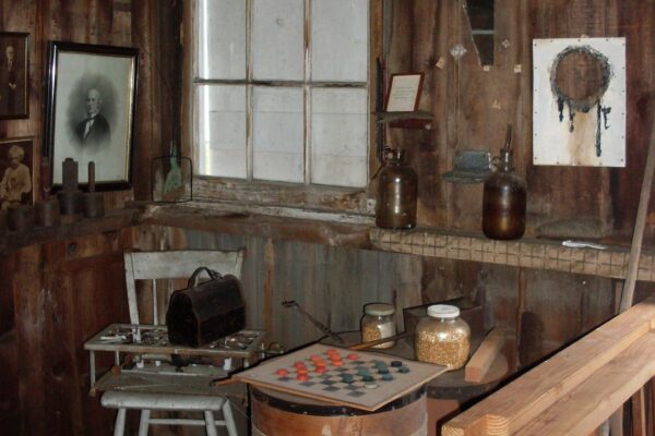 Cozy rustic room with wooden walls, vintage furniture, and nostalgic decor.